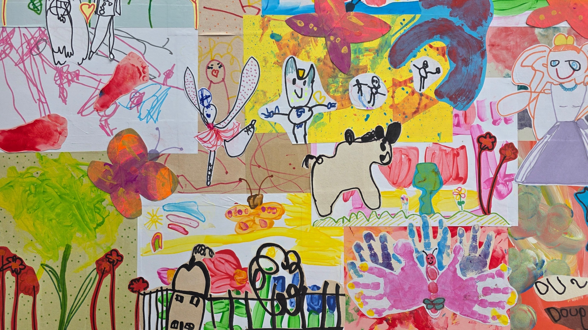 Close-up of a hand-crafted children's art collage with pink and green border details