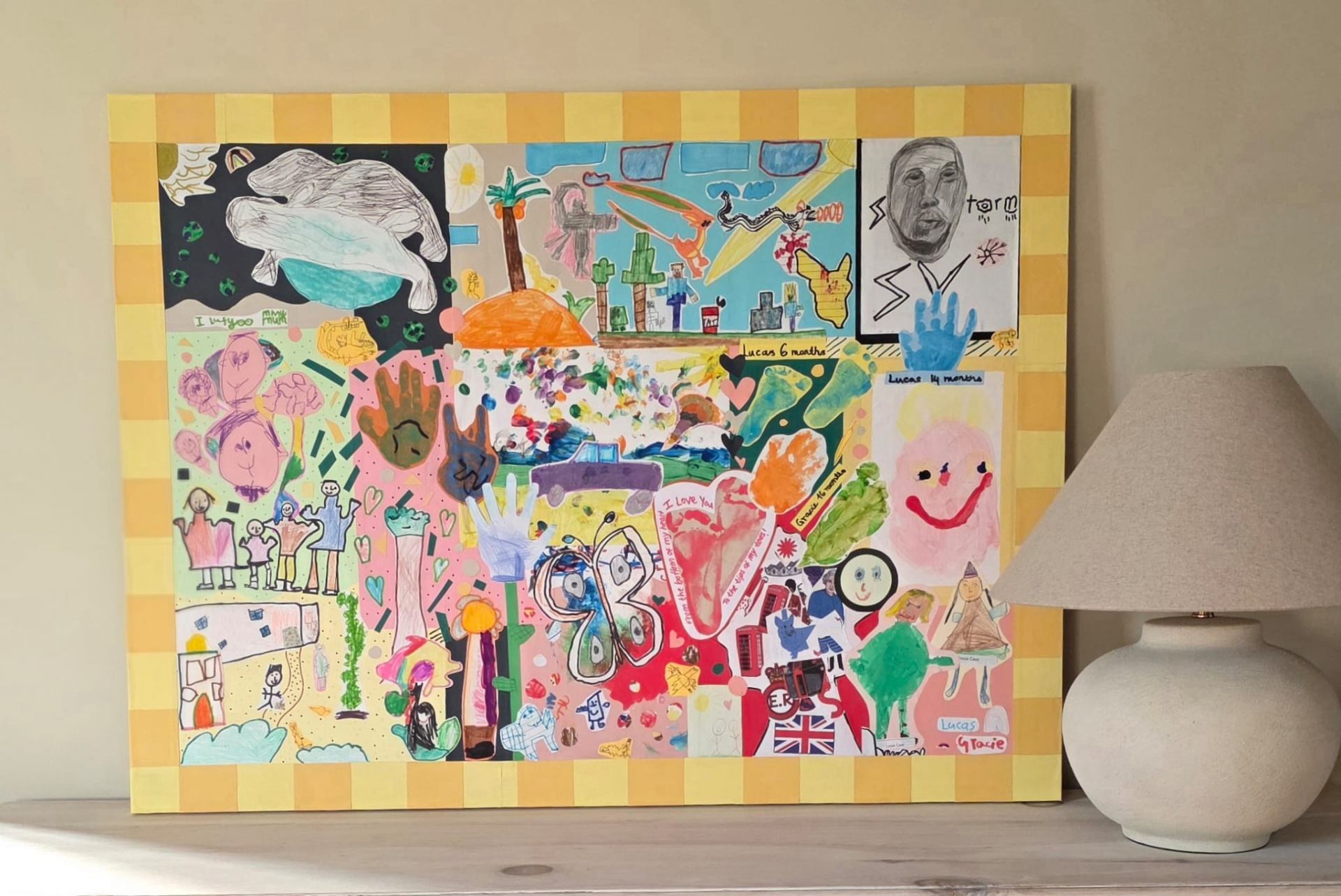 Children's collage displayed on shelf with lamp